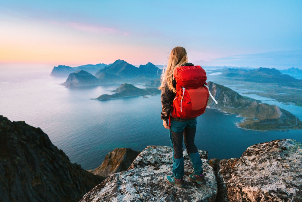 Woman,Mountaineering,With,Backpack,Solo,Girl,Traveling,In,Lofoten,Islands